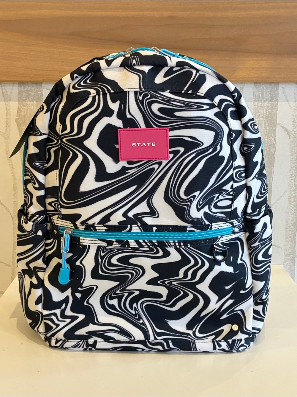 STATE Black & White Swirl Backpack with Pink Logo and Teal Accents